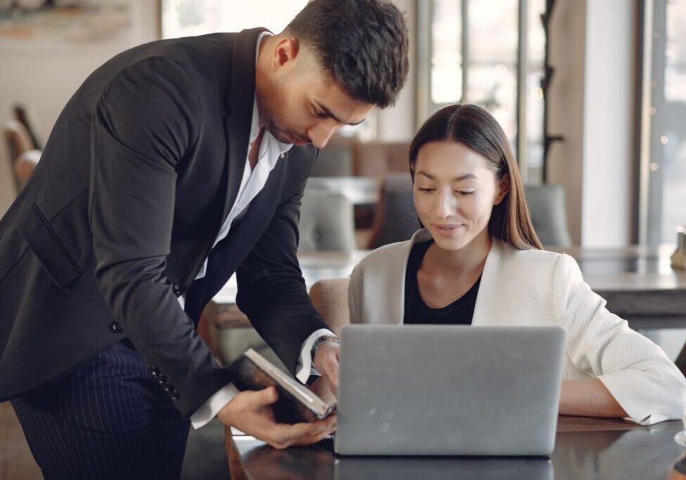 Two people looking at a PC